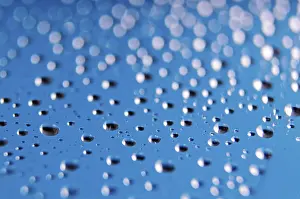Blue Background Drucke: Side view of tiny water droplets on a clear blue background