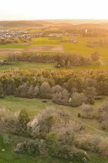 Evening Forest Scenery Drucke: View of a village surrounded by fields and forests in warm evening light