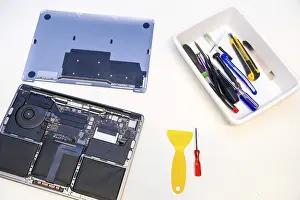 Caucasian Male Worker Drucke: Top view of a white workshop table with tools and digital tablet to repair