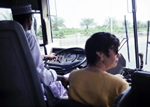 Arabian Peninsula Travel Drucke: View through the windscreen of a coach with driver and tour guide, Muscat, Oman, Asia