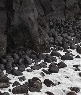 Uninhabited Rocky Coast Drucke: Volcanic cliff with spray from waves