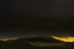 Cloudy Mountainous Terrain Drucke: Volcano cone in dark cloud cover with dramatic lighting
