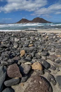West African Coast Drucke: Vulcanic cone and beach with pebbles