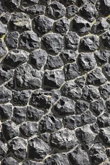 Deserted Rock Structure Drucke: Detail of a wall of black, irregular rocks