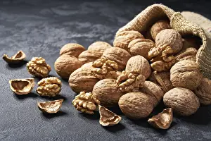 Deserted Walnut Scene Drucke: Walnuts in a bag on black background with spaces