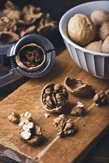 Healthy Eating Habits Drucke: Walnuts and nutcracker on wooden surface