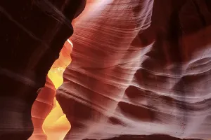 Arizona Desert Landscape Photography Drucke: Warm rays of sunlight illuminate the undulating structures inside a rock cave