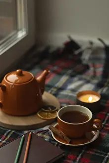 Cozy Home Decor Drucke: A warm scene of a orange tea set by a window