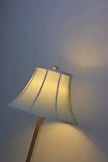 Bedside Lamp Drucke: A warmly illuminated bedside lamp with a white shade