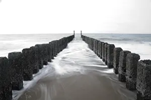 Deserted Dutch Beach Drucke: Waves against bollards, Haamstede