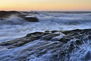 Evening Light On The Coast Drucke: Waves breaking on rocks on the coast