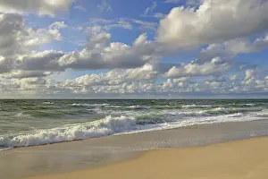 Cumulus Clouds Europe Drucke: Waves running out at the sandy beach
