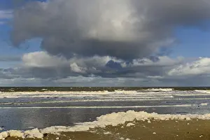 Cumulus Clouds Germany Drucke: Waves on a sandy beach with foam formation