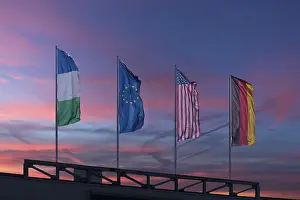 Deserted Evening Atmosphere Europe Drucke: Waving flags in the evening sky