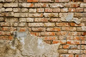 Weathered Brick Wall Drucke: Part of weathered brick wall covered with plaster