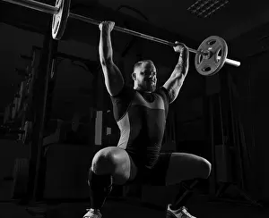 Fitness Studio Workout Drucke: Weightlifter does an exercise with a barbell