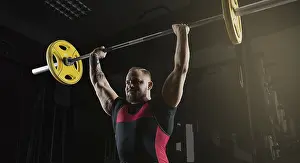 Weight Training Routine Drucke: Weightlifter does an exercise with a barbell