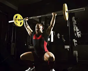 Young Weightlifter Drucke: Weightlifter does an exercise with a barbell