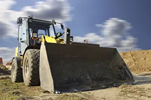 Construction Site Germany Drucke: Wheel loader at sunset, here in the RingstraBe development area (Mutterstadt)