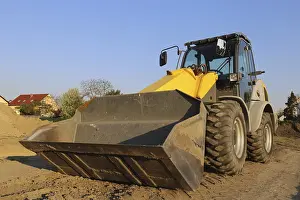 Deserted Building Site Europe Drucke: Wheel loader at sunset, here in the RingstraBe development area (Mutterstadt)