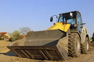 Construction Site Germany Drucke: Wheel loader at sunset, here in the RingstraBe development area (Mutterstadt)