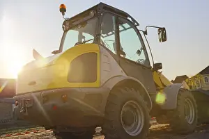 Construction Site Germany Drucke: Wheel loader at sunset, here in the RingstraBe development area (Mutterstadt)