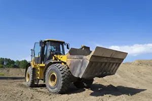 Deserted Construction Area Drucke: A wheel loader in use on a construction site