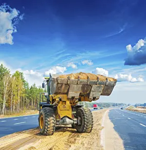 Straßenkunst Drucke: Wheelloader scoop sand construction concept