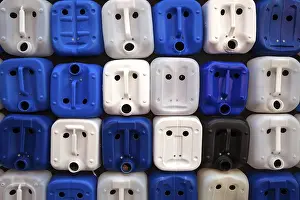 Deserted Portuguese Village Drucke: White and blue plastic canisters with faces