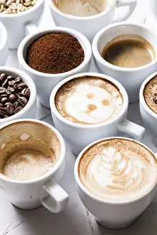Caffeine Nutrition Facts Drucke: White cups of different stages of preparing cappuccino