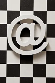 Chess Board Design Drucke: White e-mail symbol @ on a black and white checkerboard pattern background
