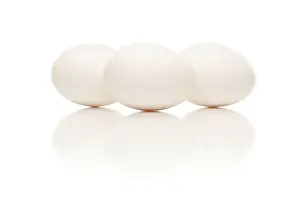 White Studio Background Images Drucke: Three white eggs isolated on a white background