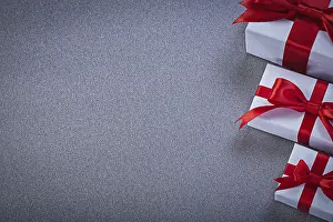 White Gift Boxes Drucke: White gift boxes with presents on grey surface holidays concept