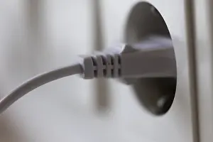 Symbolic Energy Image Drucke: White power plug in a socket on the wall