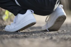 Gravel Path Germany Drucke: White trainers of an athletically dressed boy