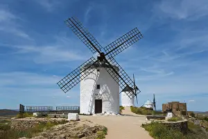 Spanish Countryside Photography Drucke: White windmill in front of a blue sky with few clouds