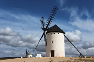 Don Quixote Route Photography Drucke: White windmill under a dramatic sky with other mills in the background