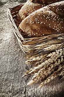 German Bakery Products Drucke: Wicker basket breadstick rye ears on sacking background