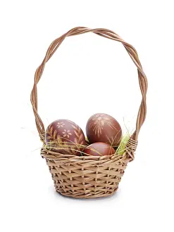 Isolated White Background Photo Drucke: Wicker basket with easter eggs shot on white