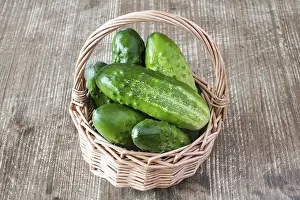 Vegetable Grocery Photos Drucke: Wicker basket of fresh cucumbers on the table