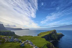 Neist Point Lighthouse Scotland Drucke: Wide angle view of a coastal landscape with cliffs under a dramatic sky