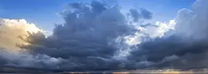 Cloudy Panoramic View Drucke: A wide panoramic view of a dramatic cloudy sky with dark storm clouds