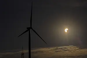 Cloudy Sky With Wind Turbines Drucke: Wind power plant, clouds, partial solar eclipse