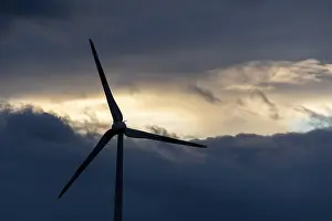 Wind Turbine Germany Drucke: Wind turbine in front of dramatic cloudy sky