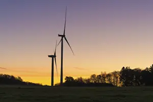 German Wind Turbine Landscape Drucke: Two wind turbines in front of a devotional sunset