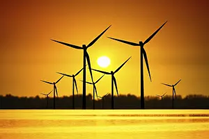 Evening Sun Setting Scene Drucke: Wind turbines over sunset
