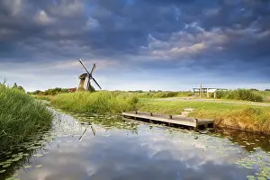 Blue Sky Reflection Drucke: Windmill on riverside with reflected blue sky