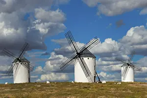 Campo De Criptana Landscape Drucke: Three windmills in front of a dramatic sky with imposing clouds