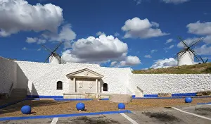 Blue Sky Windmills Spain Drucke: Two windmills and a stone wall against a blue sky full of clouds