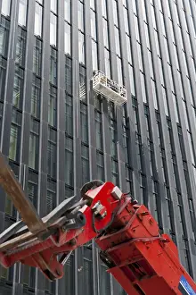 Construction Equipment Use Drucke: Window cleaner on the facade of a skyscraper